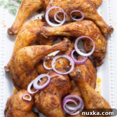 Oven-Roasted Chicken Quarters 2 chicken leg quarters with sliced purple onions and dill