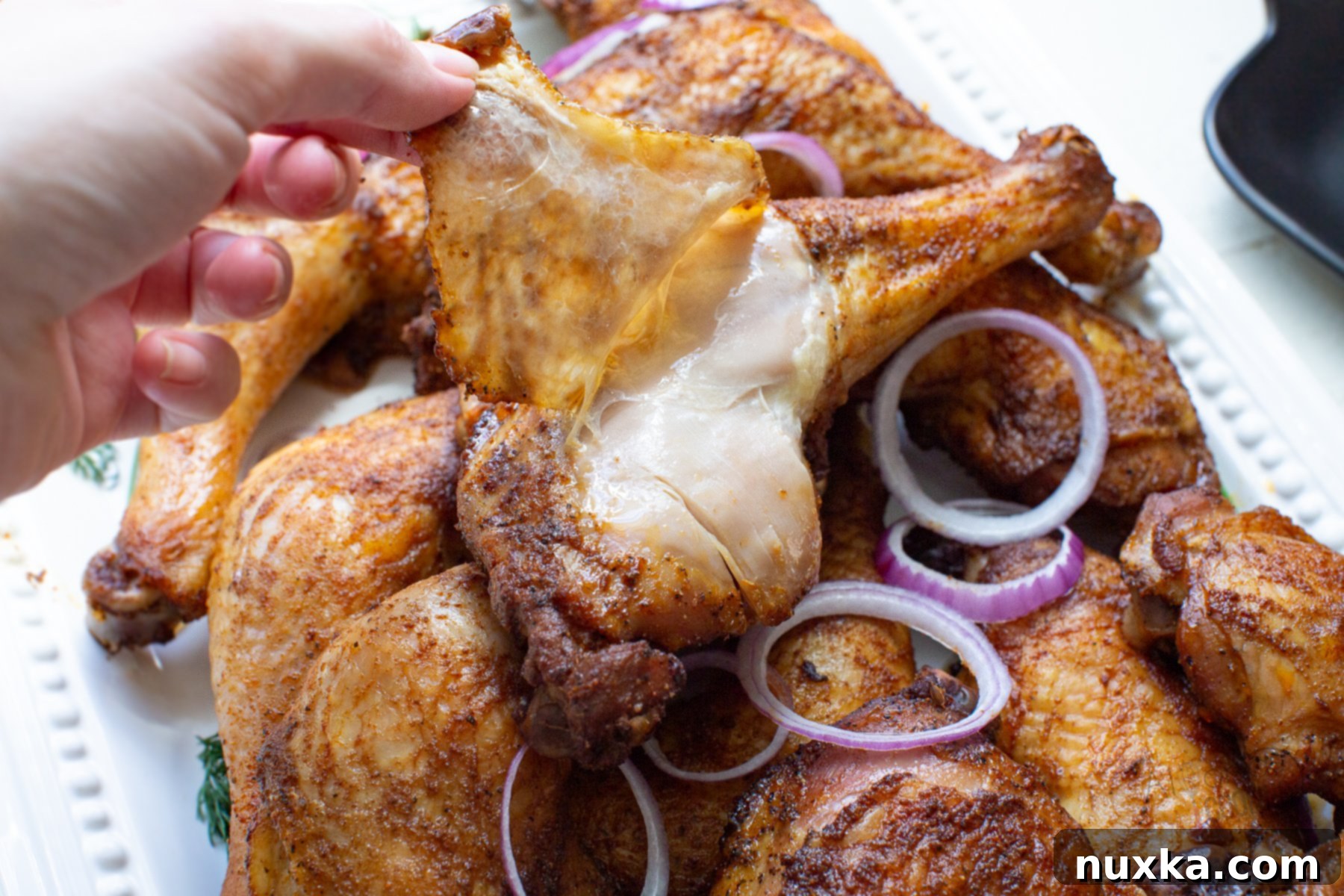 juicy dark chicken meat with crispy skins of a chicken leg quarter 