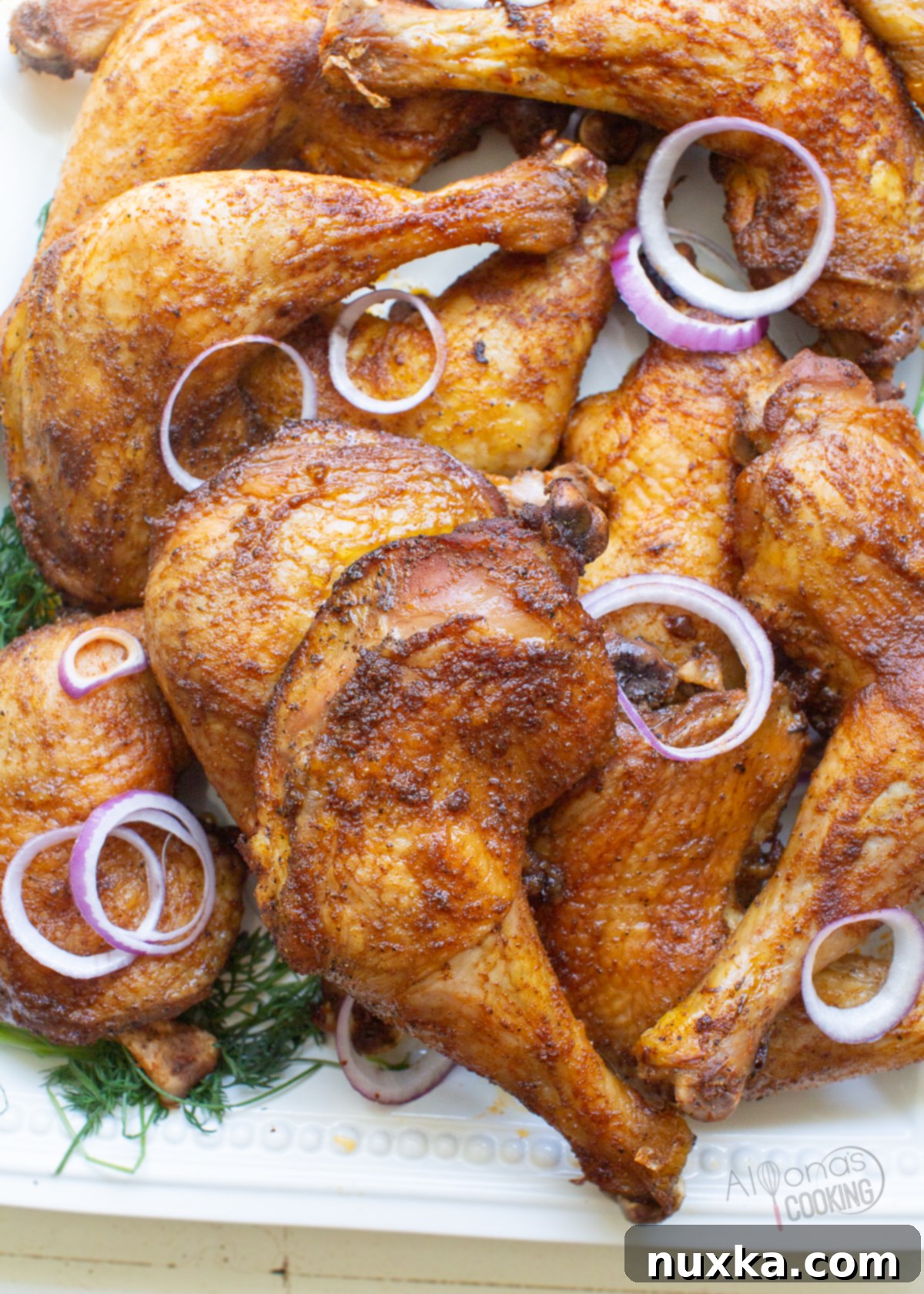 baked chicken leg quarters on a platter 