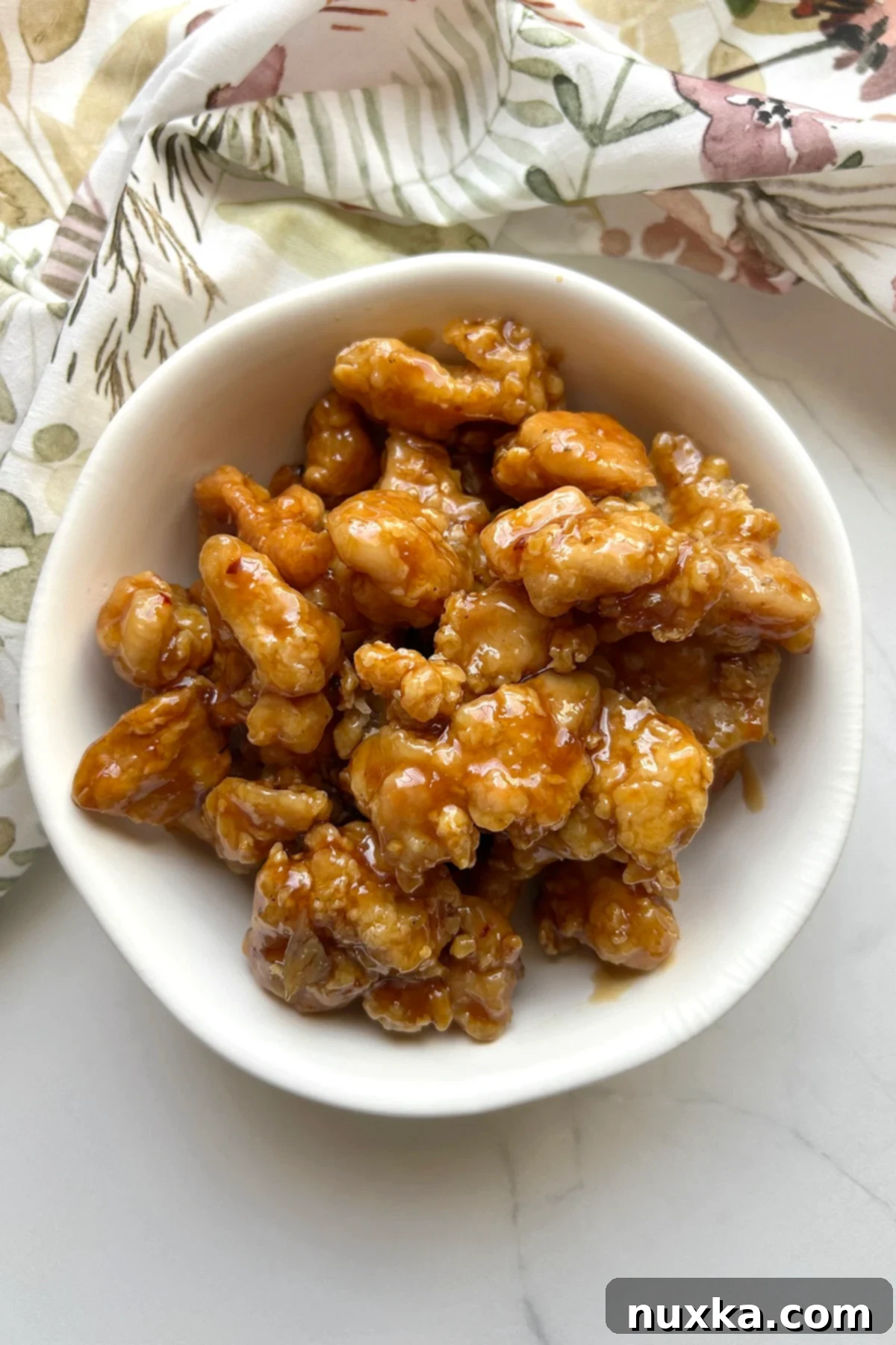 over head view of homemade Panda Express Orange Chicken in a white bowl