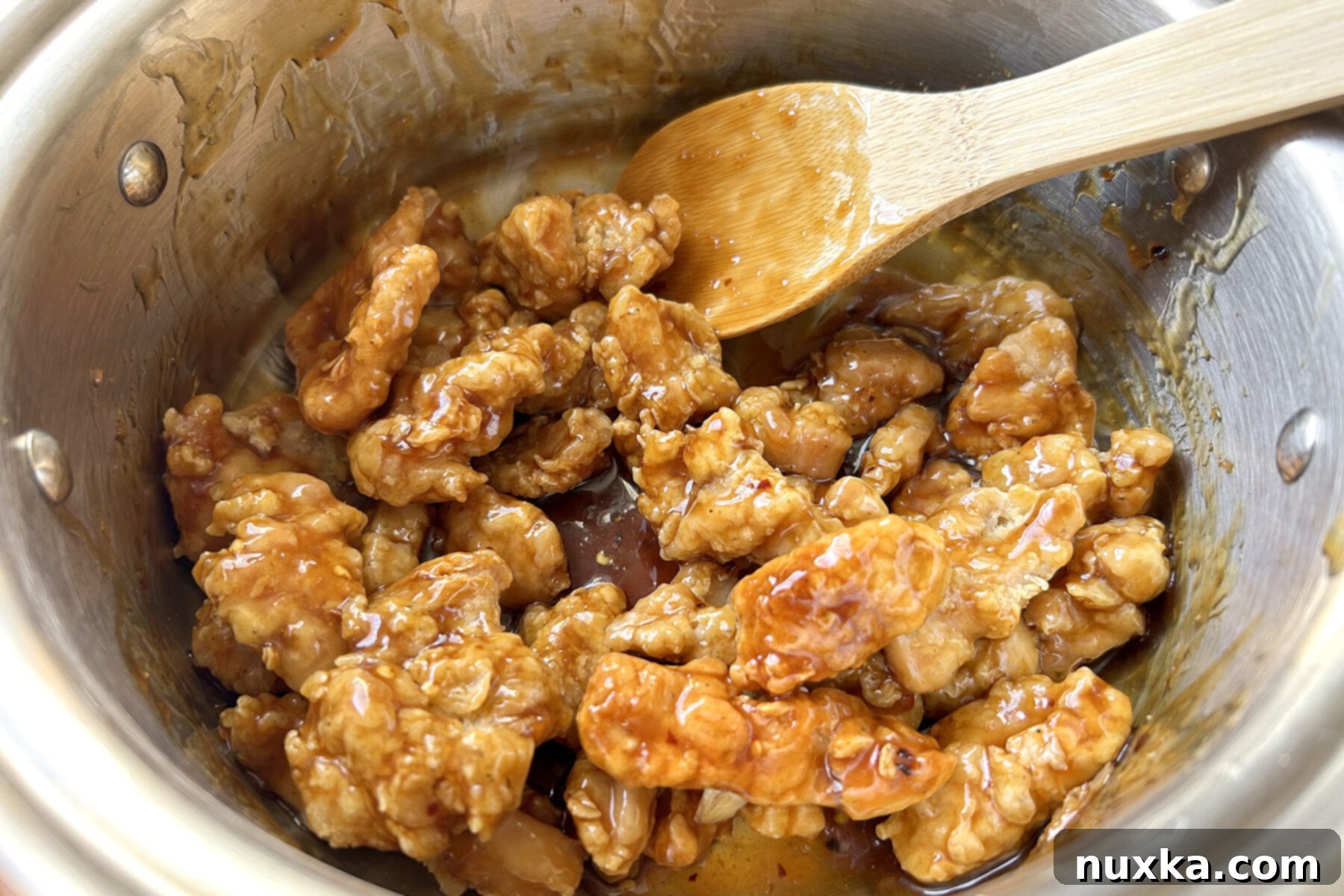homemade Panda Express orange chicken deep-fried and coated in a sweet, sour, and orange sauce