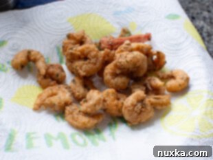 fried shrimp on a plate lined with paper towels