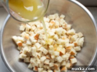coat cubed bread in the butter blend
