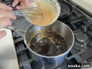 adding the therm Flo slurry to the teriyaki sauce