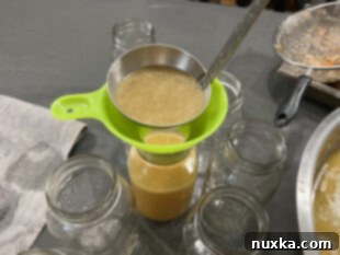 Ladle hot broth into canning jars, leaving proper headspace.