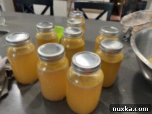 Adjusting caps on canning jars, screwing bands finger tight.