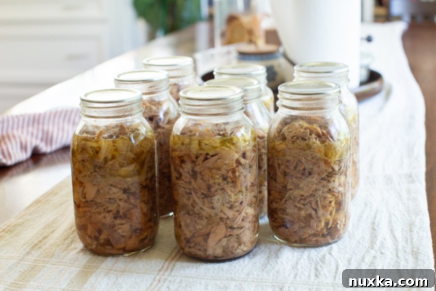 Jars of deboned cooked chicken meat, preserved and ready for future meals.