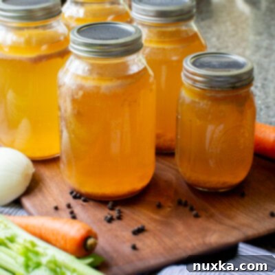 Mastering Homemade Chicken Broth Canning 4 Close-up of freshly canned chicken broth in mason jars.