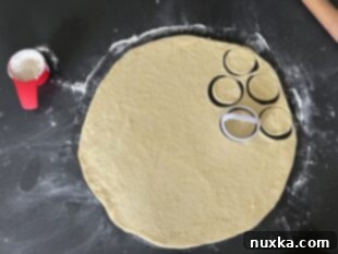 Cutting out circles from pierogi dough with a biscuit cutter