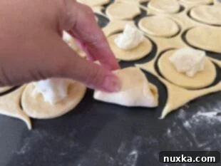 Filling and sealing pierogi with potato filling