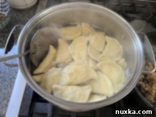 Boiled pierogi served with caramelized onions and sour cream
