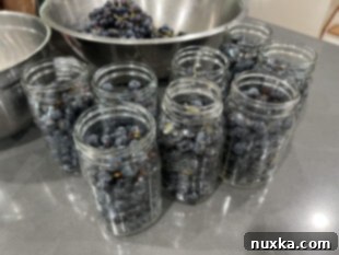 packing whole grapes into jars