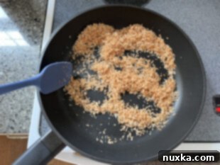 toasted coconut flakes in a skillet