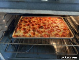 whole wheat sourdough focaccia pizza with toppings in the oven