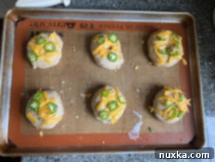 sourdough bagels topped with cheddar cheese and jalapenos