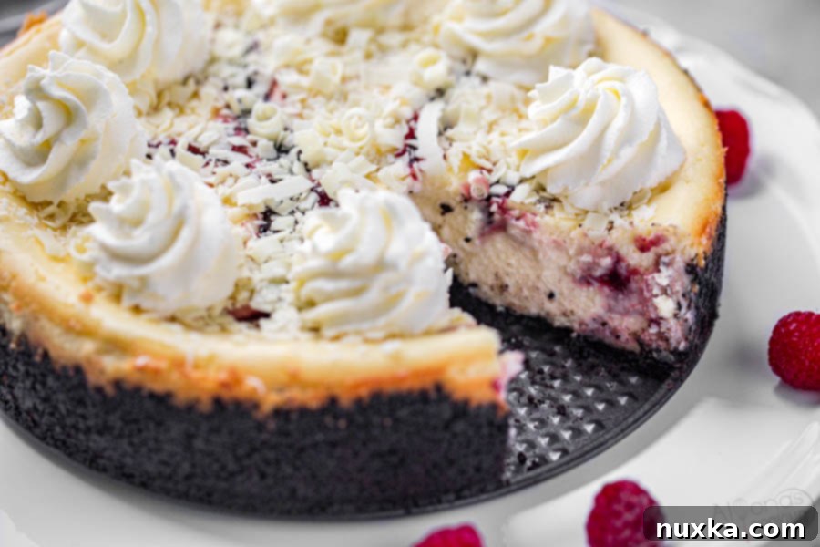 Decadent white chocolate raspberry swirl cheesecake (Cheesecake Factory copycat) ready to be served
