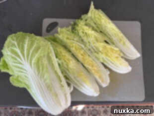 Cutting napa cabbage into quarters for easy homemade kimchi preparation