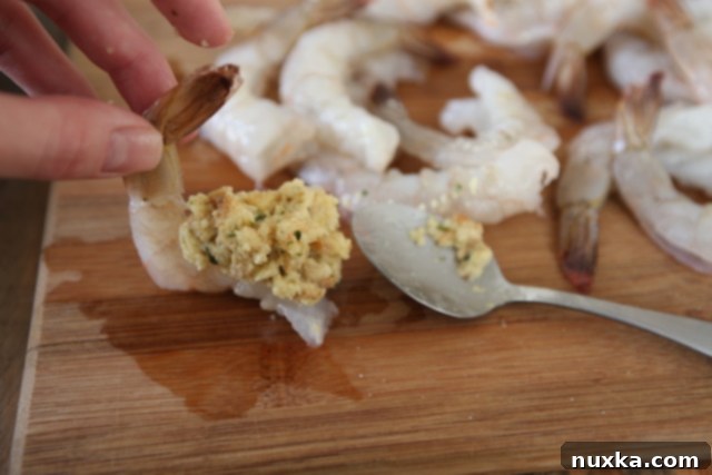 Stuffing butterflied jumbo shrimp with savory mix