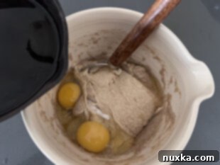 adding the remaining sourdough pancake ingredients