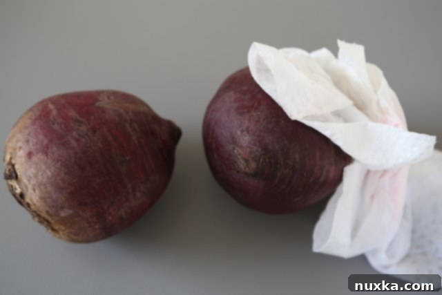 Washing and scrubbing fresh beets before roasting for salad