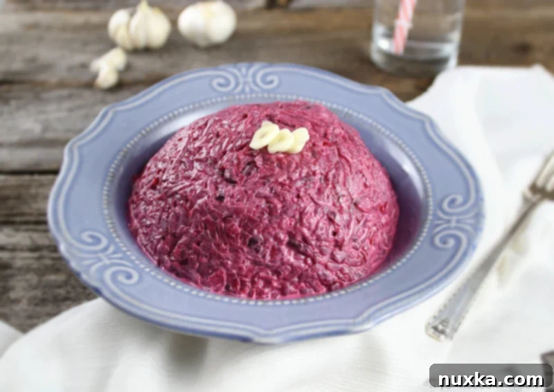 Close-up of a beautifully presented Roasted Beet Salad with Garlic and Mayonnaise, garnished with fresh herbs