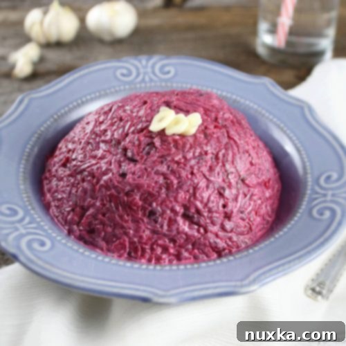 A bowl of vibrant red Roasted Beet Salad with Garlic and Mayonnaise