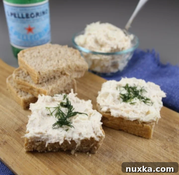 Delicious creamy canned chicken spread on homemade bread, made with cream cheese and sweet onion.