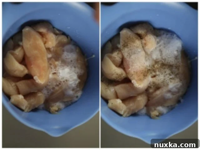 Baking soda and vinegar reacting with chicken strips in a bowl.