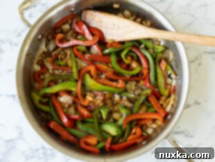 Sautéing bell peppers and onion for Cajun chicken pasta