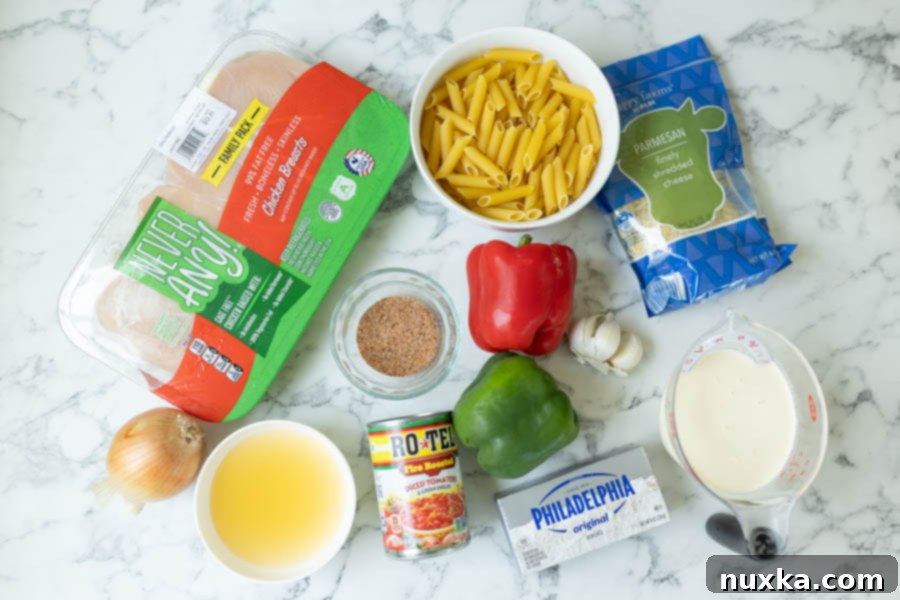 ingredients for Cajun chicken pasta (pasta, chicken breasts, parmesan cheese, Cajun seasoning, Apple cider vinegar, Rotel diced tomatoes, bell peppers, garlic, heavy cream and cream cheese)