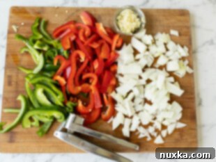 Chopping bell peppers, onion, and garlic