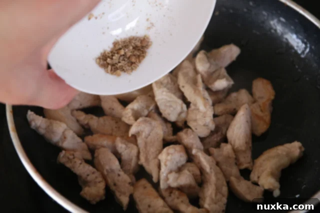 Cooked pork strips seasoned with coriander