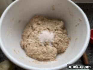 adding salt to sourdough baguette dough
