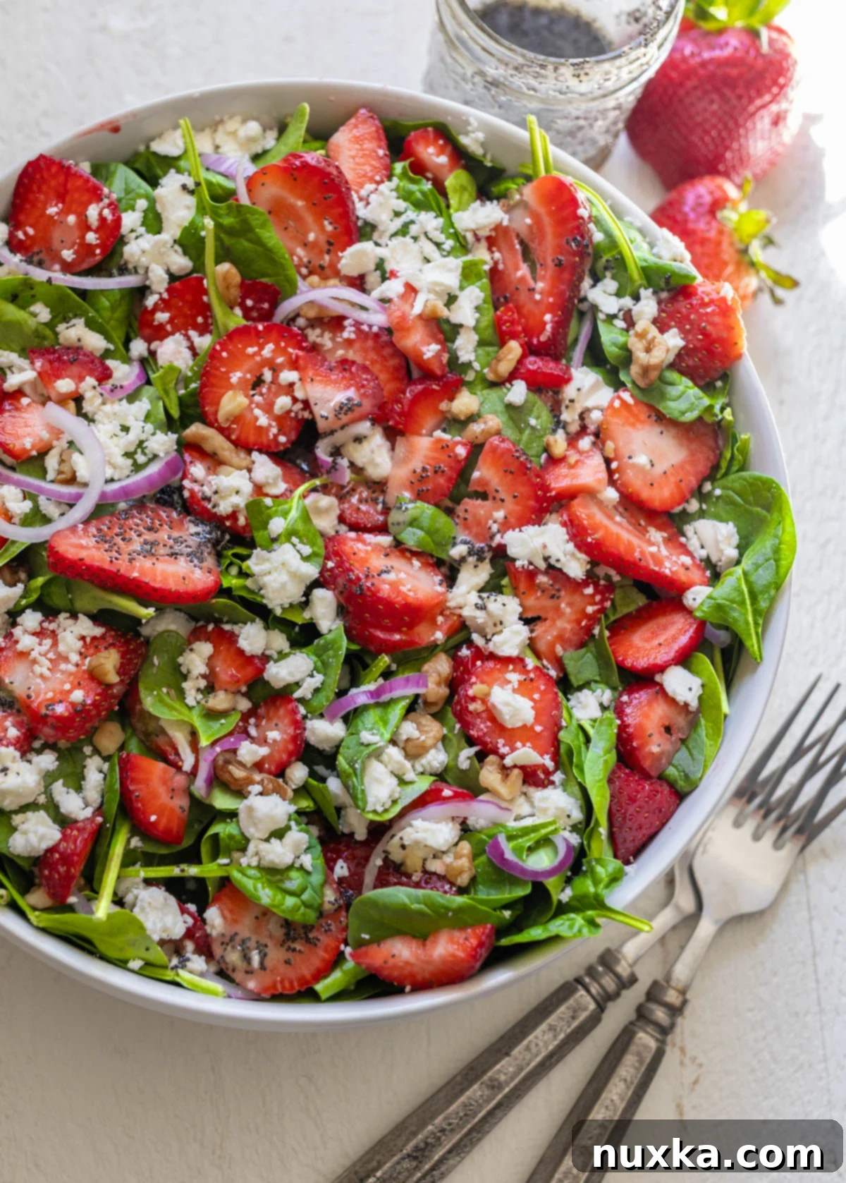 Spinach strawberry salad with a Poppy seed dressing, showcasing fresh ingredients and vibrant colors