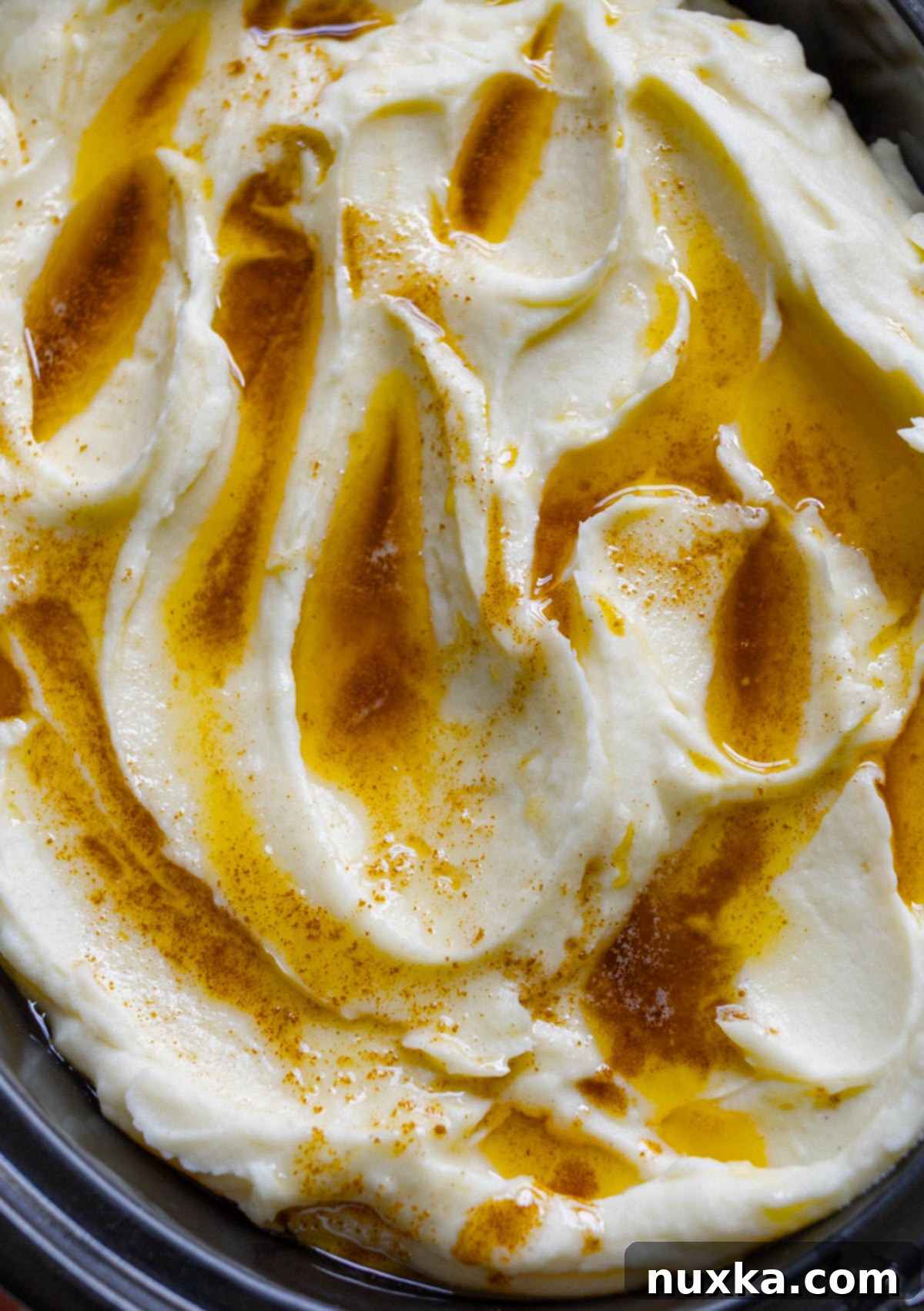 Close-up of a serving of browned butter mashed potatoes, highlighting the creamy texture and nutty flecks.