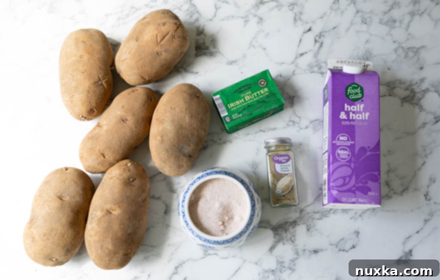 Ingredients for Judy's brown butter mashed potatoes, including Russet potatoes, sticks of butter, salt, white pepper, and half-and-half.