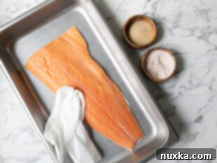 washing and pat drying a salmon fillet for curing