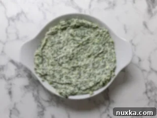 spinach dip mixture in baking dish
