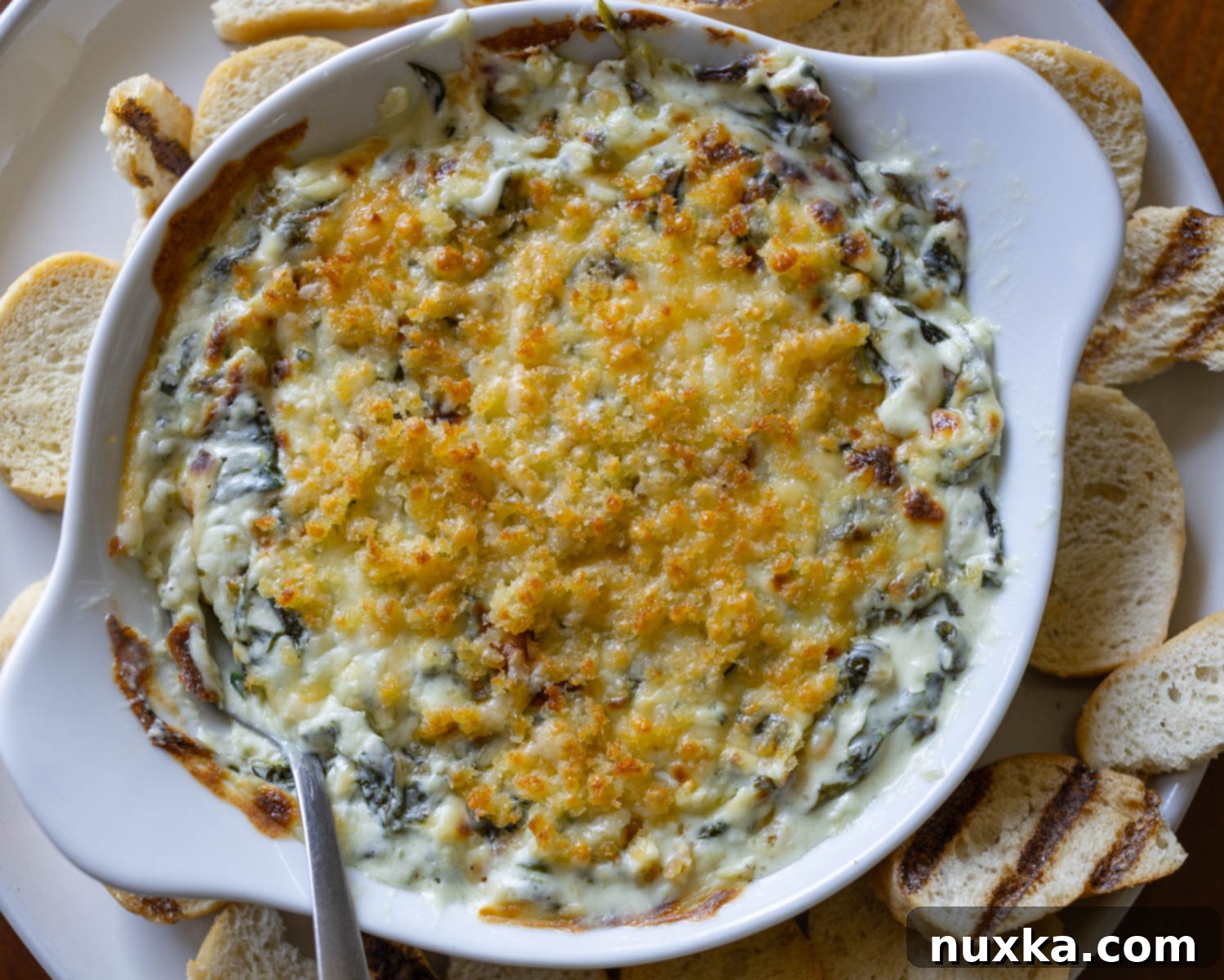 creamy, garlicky, spinach dip with a parmesan crust (Longhorn copycat)