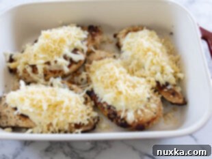 layering Longhorn parmesan crusted chicken in a casserole dish