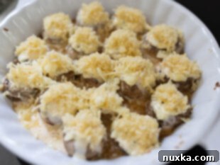 Assembling stuffed mushrooms before they broil in the oven