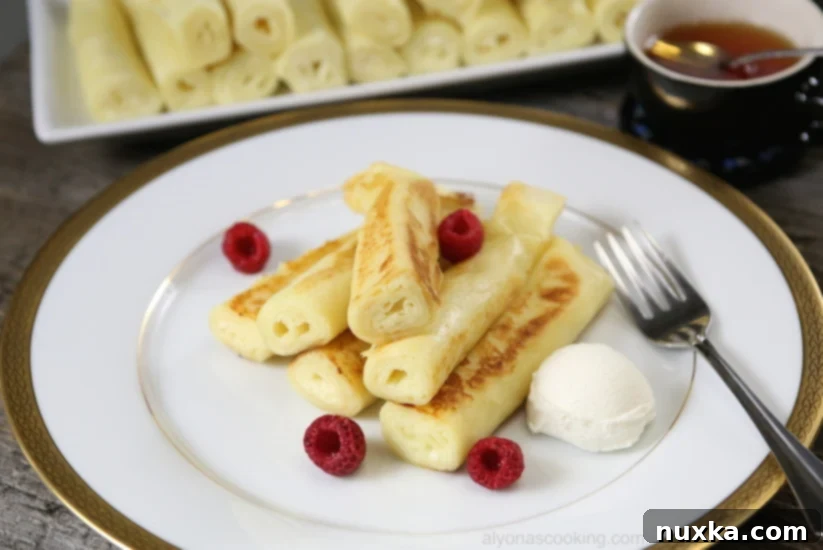 fluffy crepes-nalisniki-cottage cheese, golden crepes stacked on a plate