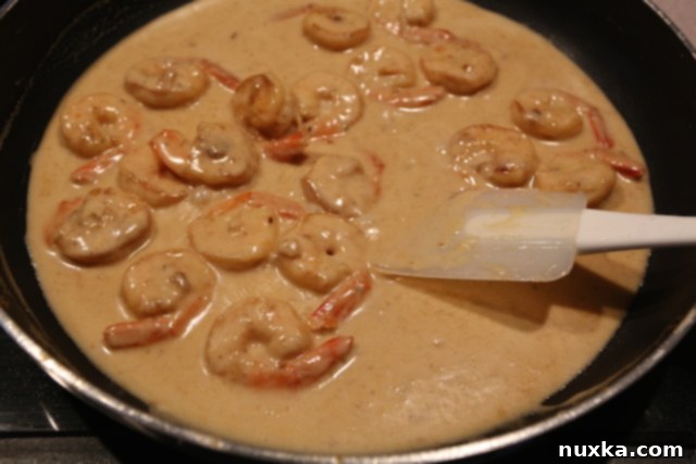 Rich, creamy shrimp wine sauce simmering in the pan, almost ready to serve.