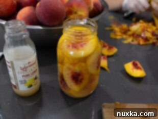 lemon juice and sugar being added to jars with peach slices