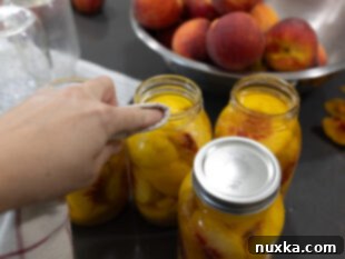 wiping jar rims clean before sealing for peach canning