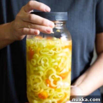 Zesty Pickled Banana Peppers 4 Homemade refrigerator pickled banana peppers in a jar, ready to be enjoyed.