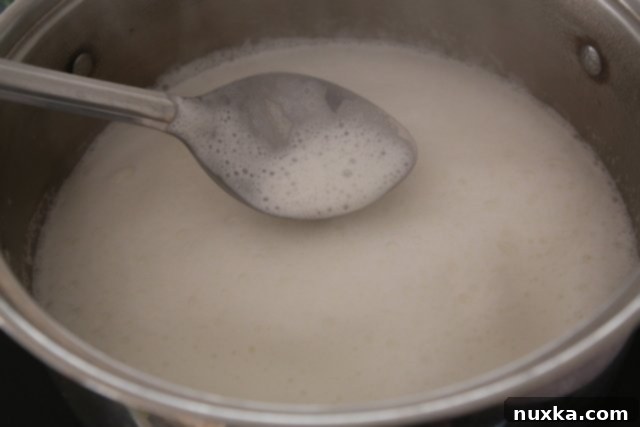 Step 2: Milk starting to foam and boil in the pot, indicating it's almost ready for pasta.