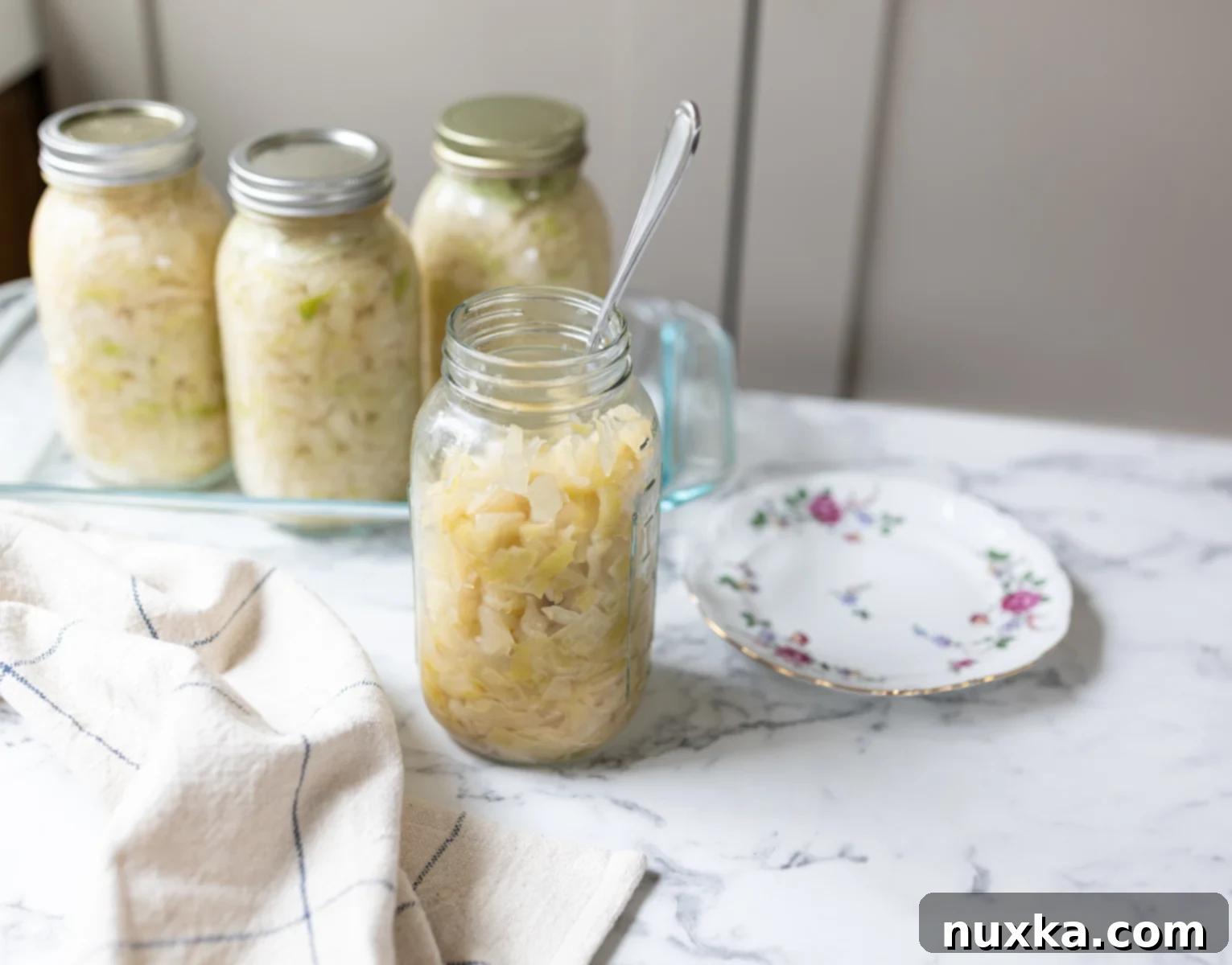 Homemade sauerkraut, close-up showing texture and color, packed in a glass jar