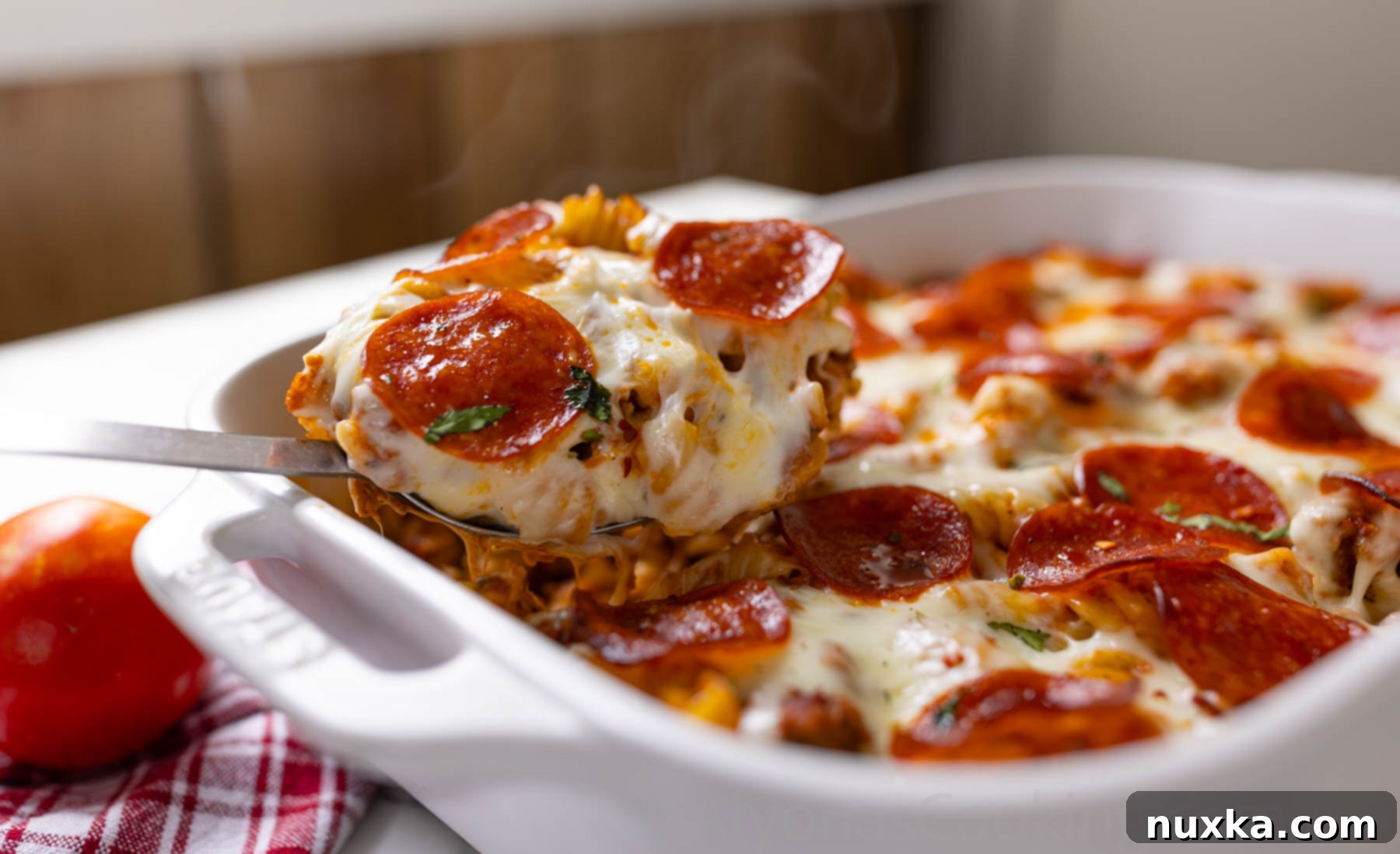 simple ground beef pizza casserole topped with pepperoni and mozzarella cheese 