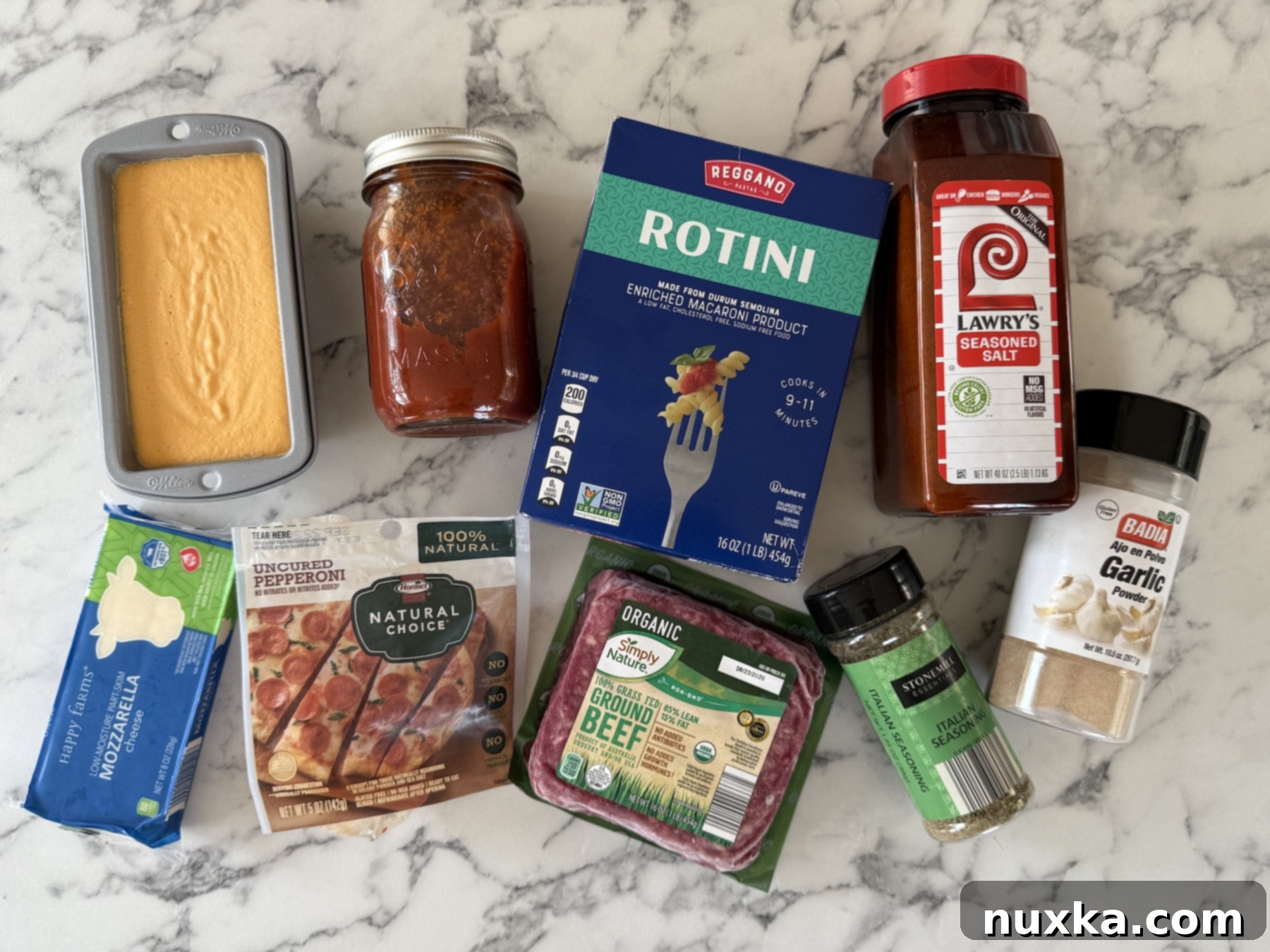 Ingredients for pizza casserole (Rotini pasta, pizza seasonings, ground beef, pepperoni slices, mozzarella cheese, pasta sauce, Velveeta cheese 
